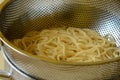 Cooked spaghetti in strainer