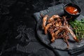Cooked Spicy fried duck tongue. Black background. Top view. Copy space Royalty Free Stock Photo