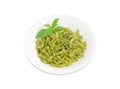 Cooked spiral pasta with sauce pesto on white dish