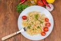 Cooked spiral pasta with shrimps, cheese on dish with fork