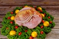 Cooked spiral sliced hickory smoked ham with fresh lemon and tomatoes Royalty Free Stock Photo