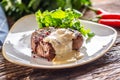 Cooked steak with mushroom sauce and green salad on the side