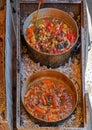 Cooked stews in metal pots Royalty Free Stock Photo