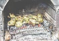 Cooked stuffed artichokes on wood barbecue grill - Vegetarian tasty dinner outdoor with friends - Focus on bottom right vegetables Royalty Free Stock Photo