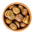 Cooked sweet chestnuts in wooden bowl over white Royalty Free Stock Photo