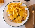 Cooked swordfish in hollandaise sauce with french fries close up Royalty Free Stock Photo