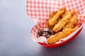 Cooked tempura shrimp in a basket with dipping sauce