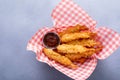 Cooked tempura shrimp in a basket with dipping sauce