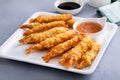 Cooked tempura shrimp on a plate with dipping sauce