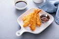 Cooked tempura shrimp on a plate with dipping sauce