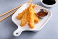 Cooked tempura shrimp on a plate with dipping sauce