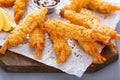 Cooked tempura shrimp on a serving board with dipping sauce