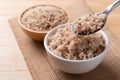 Cooked Thai brown rice in a bowl with spoon Royalty Free Stock Photo
