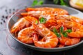 Cooked tiger prawns with parsley on a dark plate Royalty Free Stock Photo