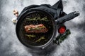 Cooked top blade, Denver steak in a pan. Marble meat beef. Gray background. Top view