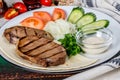 Cooked veal tongue with fresh vegetables. Shot in the decor