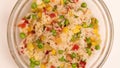 Cooked white rice with colorful vegetables pepper, carrot, green peas, corn, green beans in glass bowl, top view. Royalty Free Stock Photo