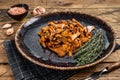 Cooked wild fried chanterelle mushrooms with onions and herbs. Wooden background. Top view Royalty Free Stock Photo