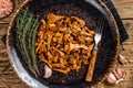 Cooked wild fried chanterelle mushrooms with onions and herbs. Wooden background. Top view Royalty Free Stock Photo