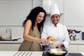 Cookery course: pouring wine into pan Royalty Free Stock Photo