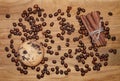 Cookie and cinnamon stick and coffee beans on a broun wooden table