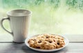 Cookie and coffee cup on rainy day window background Royalty Free Stock Photo