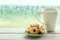 Cookie and coffee cup on rainy day window background Royalty Free Stock Photo