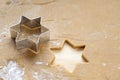 Cookie cutter in star shape on rolled out dough for homemade Christmas gingerbread, copy space