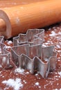 Cookie cutters and rolling pin on dough for cookies and gingerbread Royalty Free Stock Photo