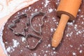 Cookie cutters and rolling pin on dough for cookies and gingerbread Royalty Free Stock Photo