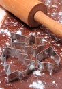 Cookie cutters and rolling pin on dough for gingerbread Royalty Free Stock Photo