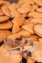 Cookie cutters in shape of star and fresh baked gingerbread or cookies for Christmas Royalty Free Stock Photo