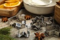 Cookie cutters on wooden table, closeup. Christmas biscuits Royalty Free Stock Photo