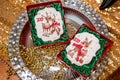 Cookie with deers and numbers 2019 in carton box on a tray with beads on golden background. Holiday sweets. New Year`s and Christ