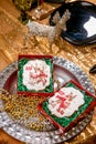 Cookie with deers and numbers 2019 in carton box on a tray with beads on golden background. Holiday sweets. New Year`s and Christ