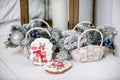 Cookie with deers and numbers 2019 near the compositions with fir branches, balls and berries in wicker baskets. Holiday sweets. N