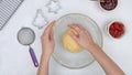 Cookie dough in a glass bowl. Chef shaping the dough into a disk.