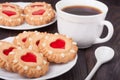 Cookie with heart jelly cup of coffee on wooden table Royalty Free Stock Photo