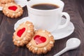 Cookie with heart jelly cup of coffee on wooden table Royalty Free Stock Photo