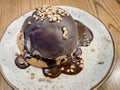 A cookie with a scoop of chocolate ice cream topped with melted chocolate and almond pieces Royalty Free Stock Photo