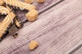 Cookie sticks with chocolate and white icing and pieces of brown cane sugar on a wooden background. Close up Royalty Free Stock Photo