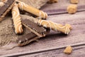 Cookie sticks with white icing and chocolate and pieces of brown cane sugar on a wooden background. Close up Royalty Free Stock Photo