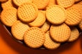 Cookies arranged on an orange surface, a tasteful and inviting presentation