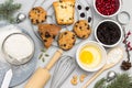 Cookies broken egg in bowl, whisk and sieve, flour and sprigs of fir on table Royalty Free Stock Photo