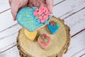 Hand holding a shortbread cookie, decorated with rolling fondant and royal icing Royalty Free Stock Photo