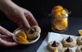 cookies with chocolate candy kiss, sliced orange pieces, hand holds plate with desert Royalty Free Stock Photo