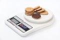 Cookies with chocolate filling on a digital scale Royalty Free Stock Photo