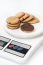 Cookies with chocolate filling on a digital scale Royalty Free Stock Photo