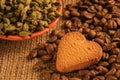 Cookies on coffee beans on burlap and on the background of cardamom and coffee Royalty Free Stock Photo