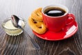 Cookies, coffee on saucer, condensed milk in bowl, spoon Royalty Free Stock Photo